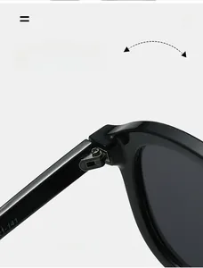 Detail of durable textured metal hinges on oversized black glossy pilot sunglasses