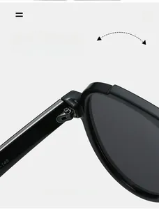 Macro view of durable metal reinforced hinge on black oversized sunglasses