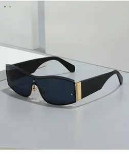 Detail of square oversized sunglasses with black frame and golden metal hinge accents