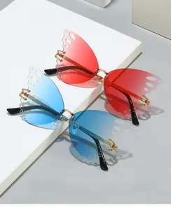 Close-up of butterfly-shaped rimless sunglasses with gradient lenses and gold metal frames