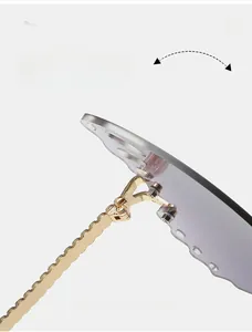 Macro shot of durable golden textured hinges and grey gradient lenses on rimless sunglasses