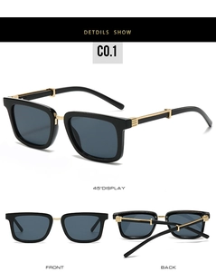 Detail view of square black sunglasses with gold metal temples and textured grid pattern