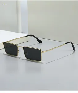 Macro view of vintage rectangular sunglasses with slim gold metal frame and black lenses