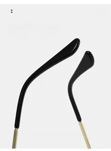 Close-up of curved black temple tips and golden metal hinges on square sunglasses