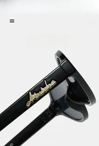 Detail of super elastic black temple with golden script branding and texture material