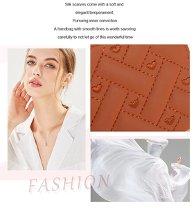 Close-up of elegant embroidery on brown leather with heart pattern and minimalist necklace