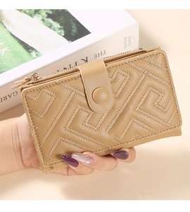 Detail of camel PU leather wallet featuring geometric embroidery and zip closure design