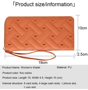 Detail of coral orange PU leather long wallet with diamond quilted heart embroidery