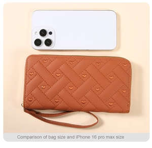 Size comparison between the caramel quilted heart wallet and an iPhone 16 Pro Max