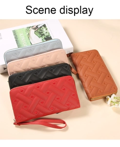 Detailed view of woven quilted wallets with heart embroidery in five elegant colors