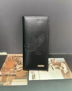 Close-up of black lychee grain leather wallet with bird embossing and metal logo