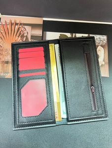 Detail view of long black wallet with multiple card slots and secure zipper pocket