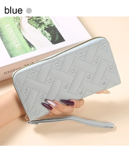 Detailed view of light blue embroidered long wallet with wristlet and heart pattern