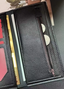 Close-up of black leather men's long wallet with multi-card slots and metal zipper pocket