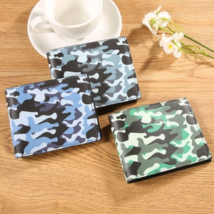 Men's camouflage bi-fold wallets in blue, grey, and green on a wooden tabletop