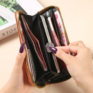 Women's long zip-around wallet in caramel leather with multi-card slots and phone holder