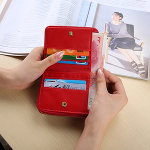 Macro detail of red folding wallet interior showing multiple card slots and secure snap