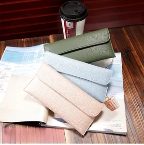Detailed view of long envelope wallets in Morandi colors with pebbled texture