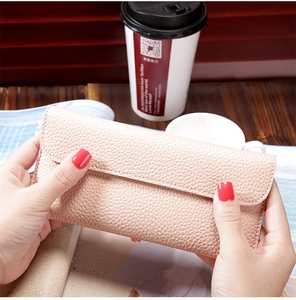 Detailed view of women long wallet featuring pink lychee pattern and envelope closure