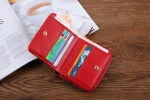 Detail view of red leather wallet interior with multiple card slots and a coin pocket