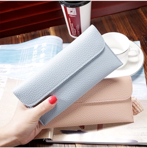 Detailed view of light blue and pink pebble grain long wallets for women with flap design