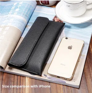 Long black litchi pattern wallet for women shown next to iPhone for size comparison