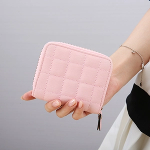 Short pink quilted faux leather wallet for women with zipper closure and hand-held view