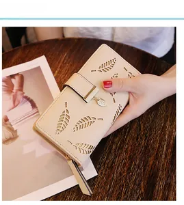 Détails de l'élégant portefeuille long beige avec motifs de feuilles dorées évidées