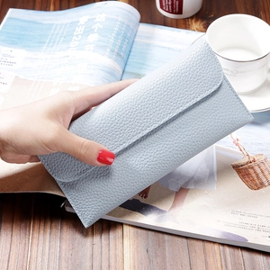 Light blue pebbled leather long wallet for women with large capacity and flap closure
