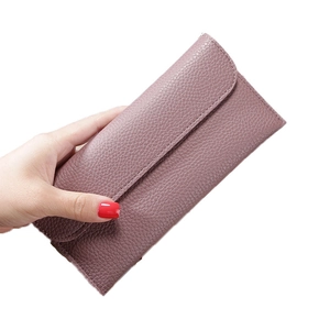 Elegant long slim wallet for women in dusty rose with litchi grain texture and snap closure