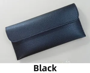 Detail view of long black wallet featuring premium lychee pattern leather and flap closure