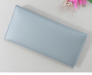 Detailed macro view of the light blue long wallet showing fine lychee pattern leather texture