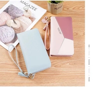 Detail of color-block patchwork long wallet with wrist strap and tassel zipper puller