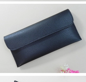Detail view of the black pebble grain leather texture on this stylish long wallet for women