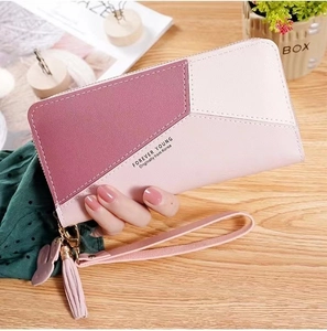 Detail of pink color-block long wallet with wrist strap, tassel and rabbit charm