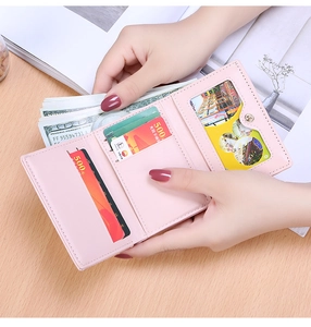 Detailed interior of a pink trifold wallet showing card slots and a clear ID window