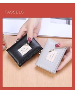 Close-up of black and grey PU leather trifold wallets with pearl pin details