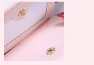 Detail of pink leather wallet featuring a gold magnetic snap button and card slot
