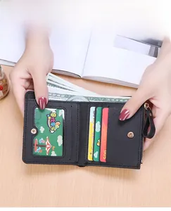 Interior details of black leather tri-fold wallet showing card slots and zipper pocket