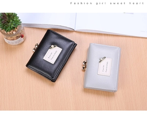 Short tri-fold wallets in black and grey PU leather with pearl pins and metal clasps