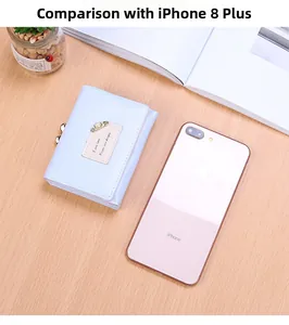 Light blue tri-fold wallet shown next to a smartphone for size scale on a wooden table