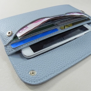 Slim long bi-fold leather wallet in foggy blue with pebbled texture and metal snap button