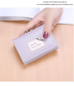 Detail of light purple trifold PU wallet with vintage gold clasp and pearl pin detail