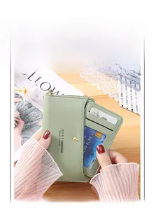 Detail of mint green PU leather card wallet with multi-slot storage and snap closure