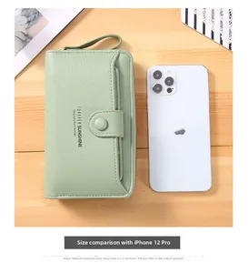 Long wristlet wallet in light green compared with iPhone 12 Pro for size scale