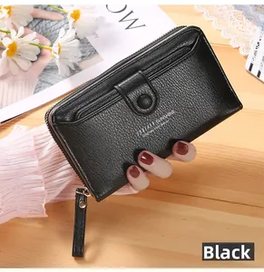 Close-up of black lychee grain leather wallet featuring a zipper and snap pocket