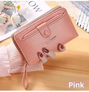 Detailed view of a pink long wallet with wrist strap and litchi grain texture finish