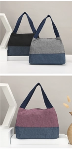 Drei mehrfarbige Segeltuch-Lunchtaschen in Schwarz, Lila und Grau mit blauen Trägern