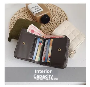Detailed view of quilted mini wallet showing card slots and spacious cash compartment