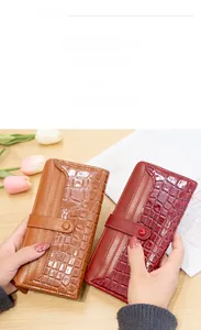 Detail of long stone pattern PU leather wallet with snap closure in brown and burgundy